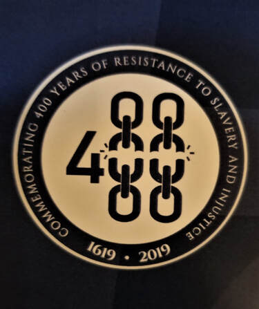 Logo of the symposium depicting the number 400 using broken chains for the zeroes, inside a circle stating Commemorating 400 Years of Resistance to Slavery and Injustice 1619-2019. (Photo by M. Luckey, with permission from Haas Institute for a Fair and Inclusive Society)Picture