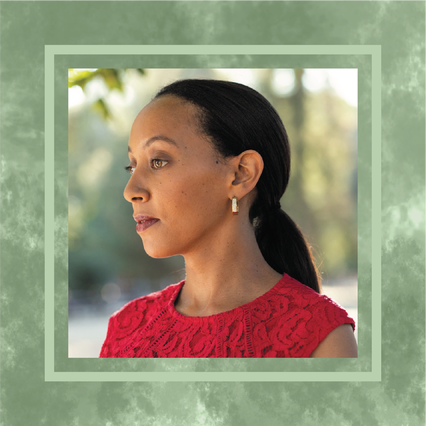 A portrait photo of Haben Girma standing outdoors. She’s wearing a red top, gold earrings, and has her hair pulled back in a ponytail. The photo is in a textured green frame.