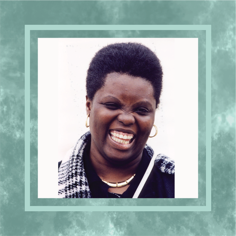 A photo of Lois Curtis from the shoulders up, laughing. She has a short black afro and is wearing gold hoop earrings, a gold necklace, and black shirt with a black-and-white scarf. The photo is in a textured turquoise frame.